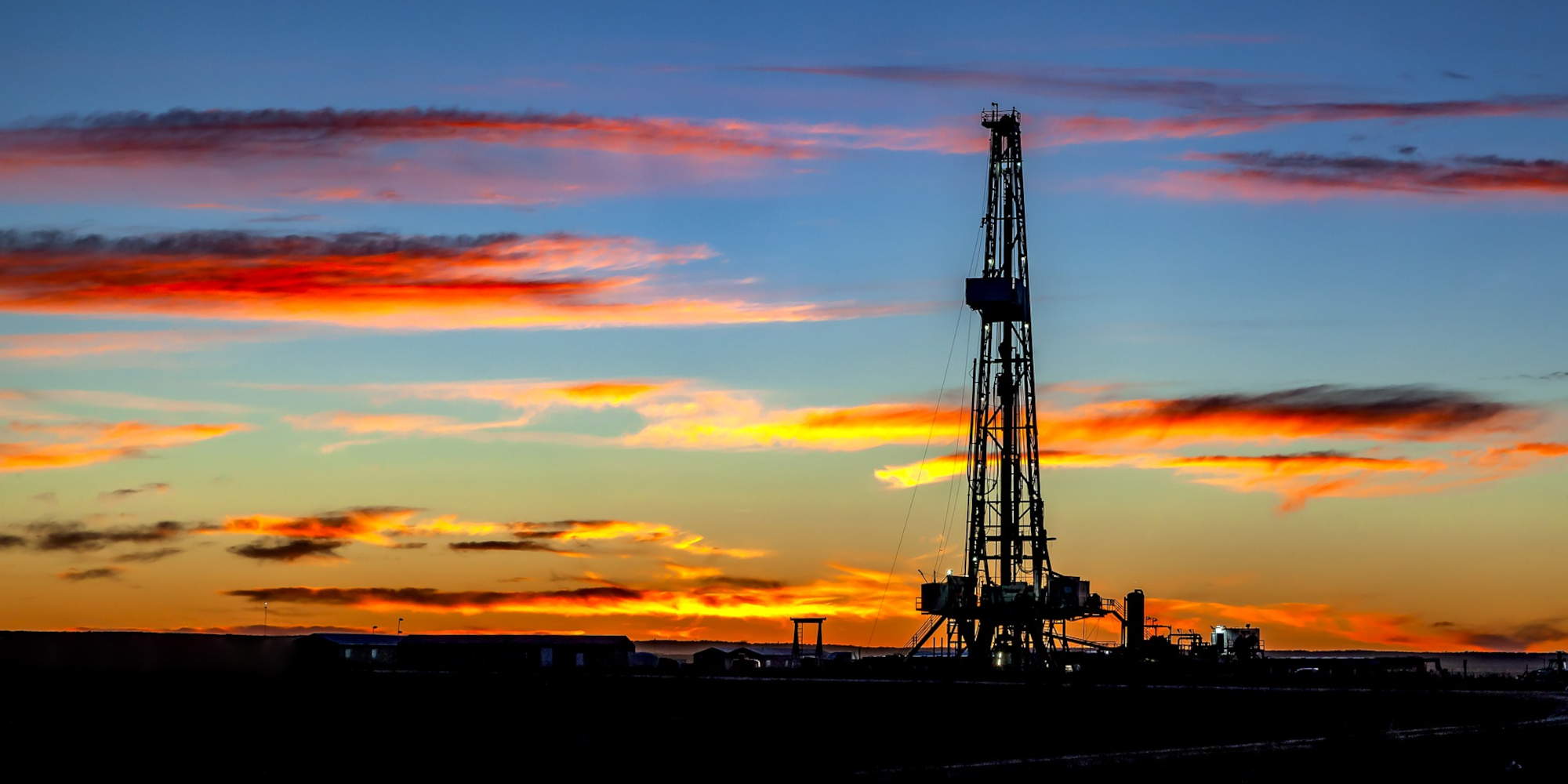 Εγκατάσταση εξόρυξης πετρελαίου εν μέσω πίεσης στην παγκόσμια οικονομία με φόντο το ηλιοβασίλεμα