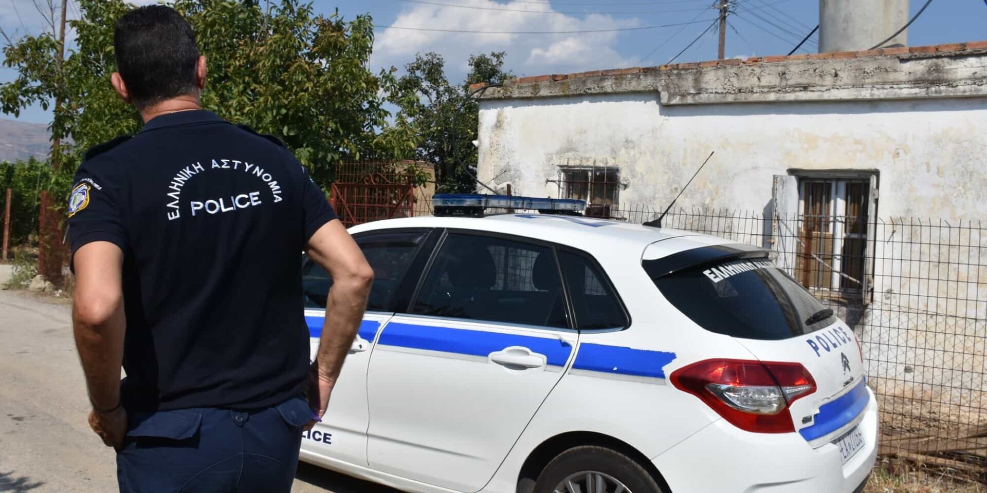 Ένας αστυνομικός μπροστά από περιπολικό