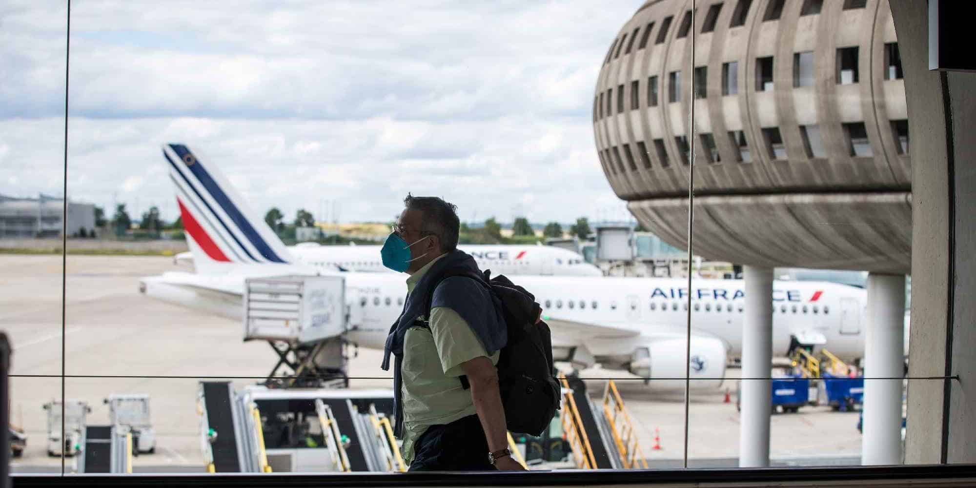 Επιβάτης περπατάει δίπλα σε διάδρομο καθώς τα αεροσκάφη της Air France στο αεροδρόμιο στο Παρίσι