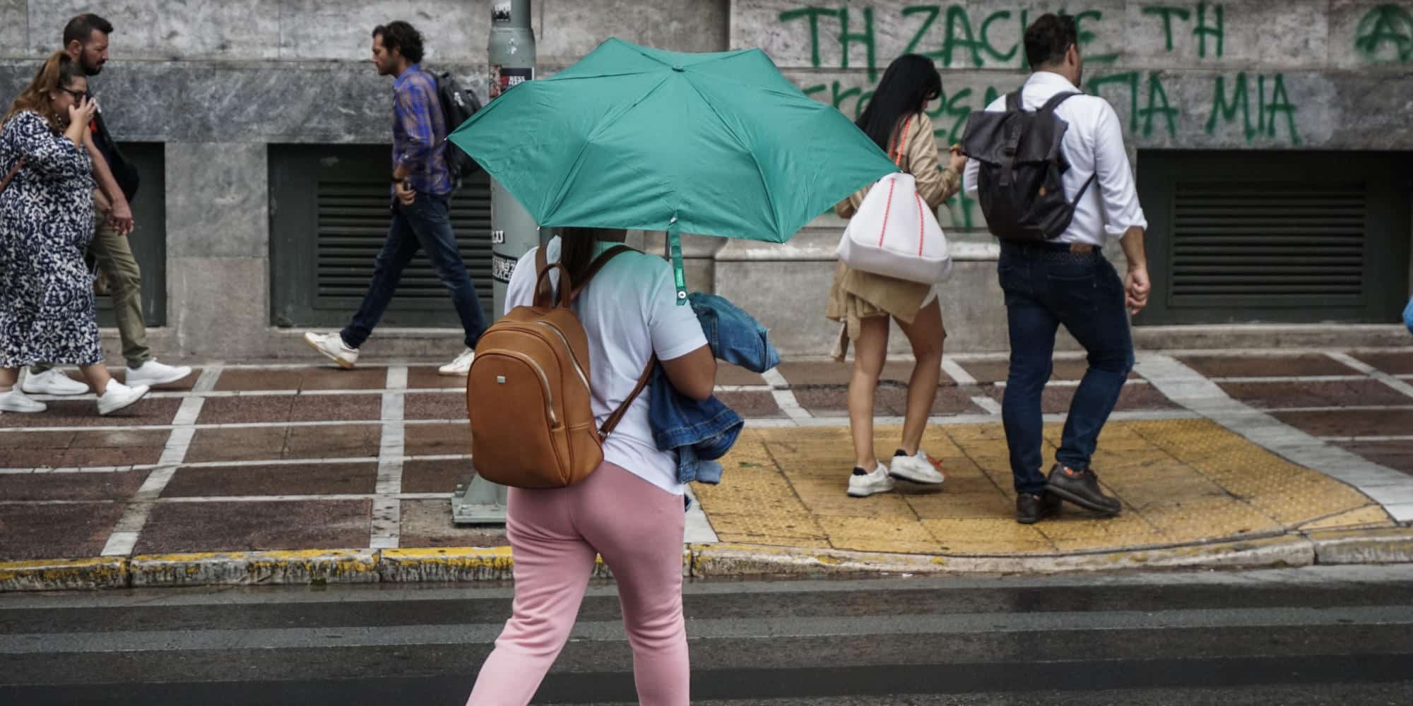 Γυναίκα στο κέντρο της Αθήνας με ομπρέλα