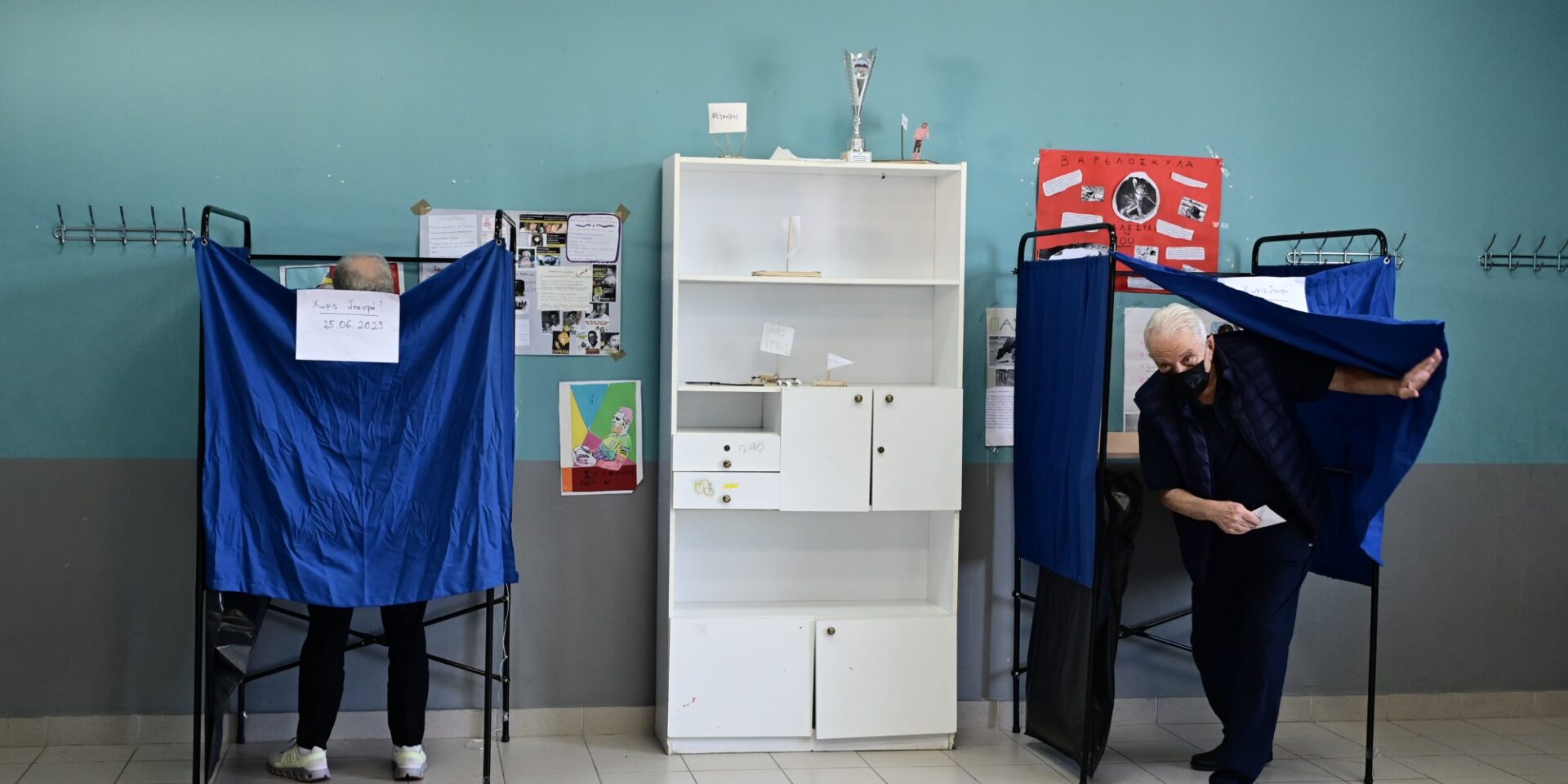 Κόσμος ψηφίζει μέσα στο παραβάν για τις εκλογές - κάλπες